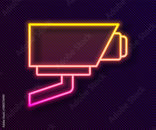 Glowing neon line Security camera icon isolated on black background. Vector.