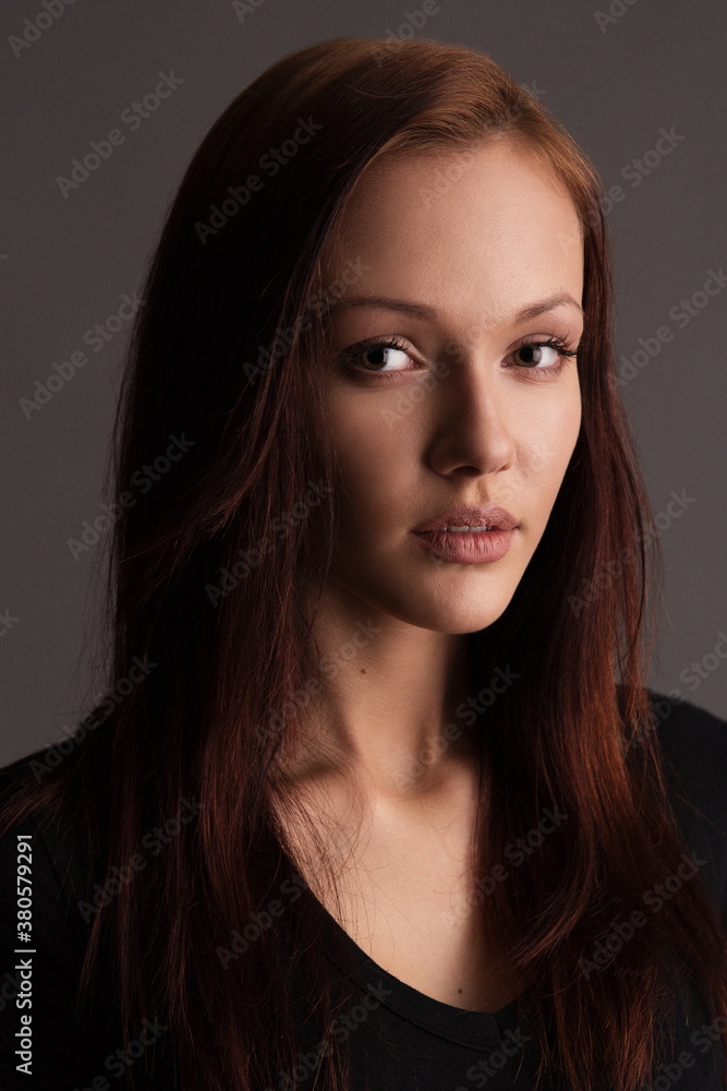 Naklejka premium Beauty woman face portrait. Beautiful spa model girl with perfect fresh clean skin. Glitter nude makeup Youth and skin care concept. Isolated on gray background