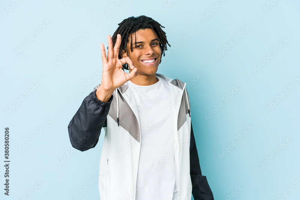 Young african american sport man cheerful and confident showing ok gesture.