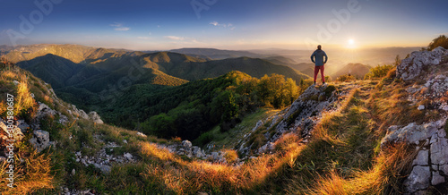 Peak Panoramic view on mountains hills Successfully achieving your goal, Silhouette male on the mountain. Success Business Leadership, Winner Man on top. Business Sport and active life concept