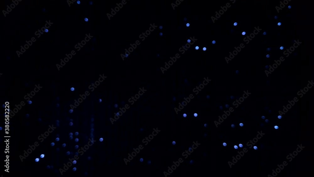Flashing lights of blue and white colors glitter on black graphical