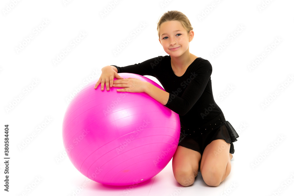 little girl doing exercises on a big ball for fitness. little girl doing exercises on a big ball for fitness.