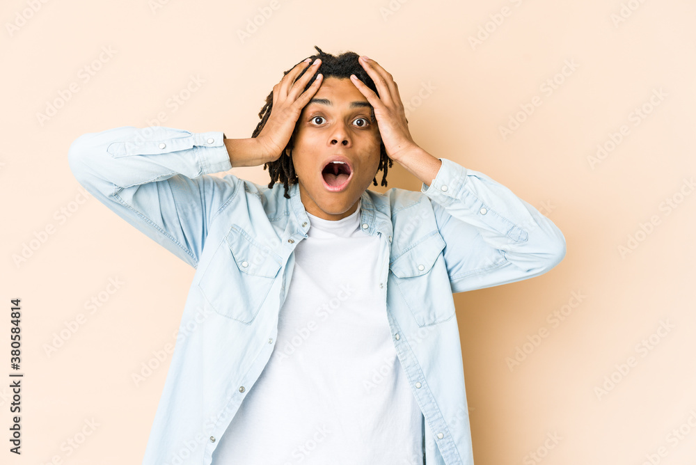 Young african american rasta man screaming, very excited, passionate, satisfied with something. Young african american rasta man screaming, very excited, passionate, satisfied with something.