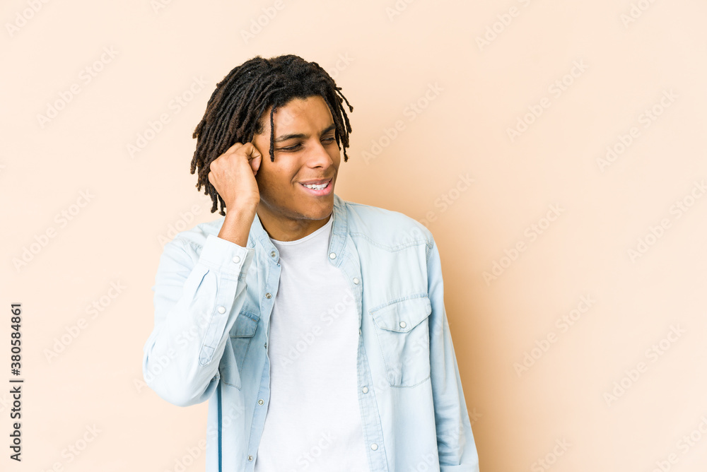 Young african american rasta man having a neck pain due to stress, massaging and touching it with hand.