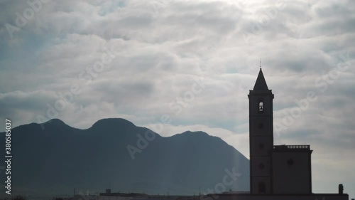 Time lapse of clouds moving over church San Miguel on coastal road in Almadraba de Monteleva, Cabo de Gata Nijar Natural Park, Andalusia Spain. photo