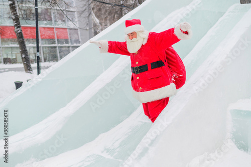 Santa Claus is rolling down the ice slide