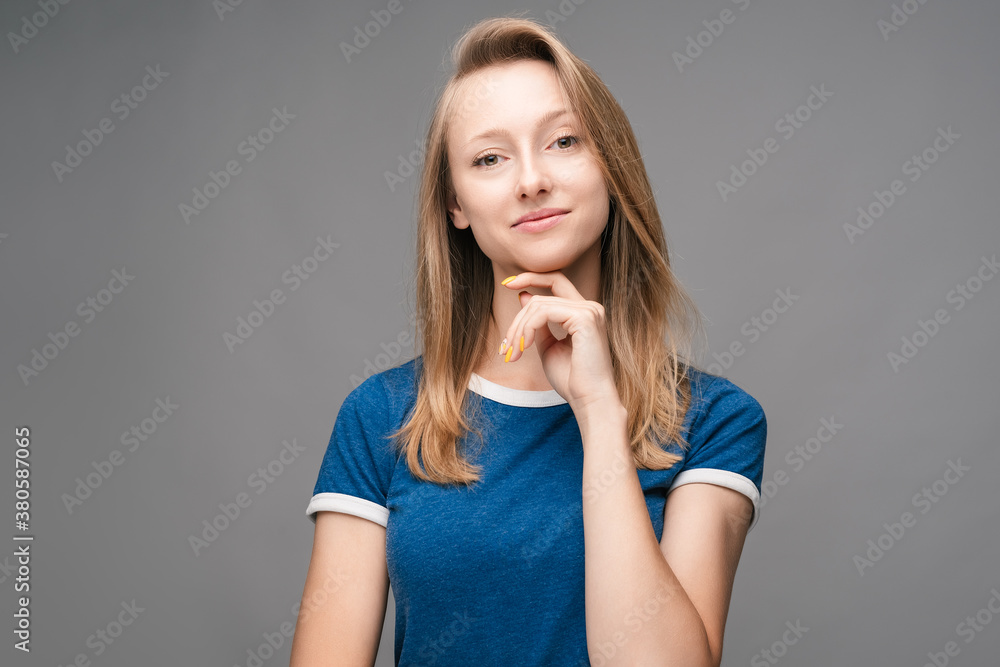 Positive Young blonde woman laughing. Studio shot, gray background. Human emotions, facial expression concept Positive Young blonde woman laughing. Studio shot, gray background. Human emotions, facial expression concept