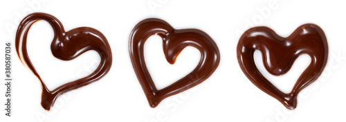 Chocolate sauce isolated. Chocolate heart swirl set on white. Top view. Chocolate syrup heart pattern flat lay.
