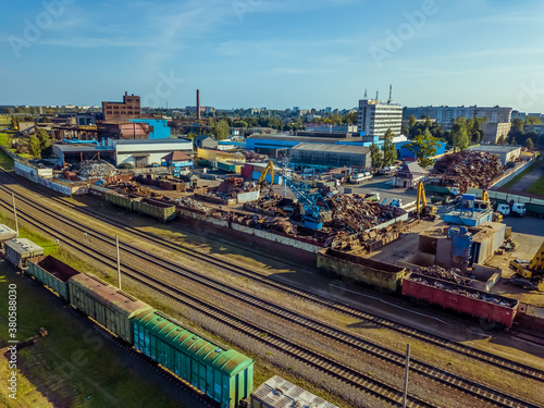 Industrial scene with trains, railway platform, Metalworking plant, top view from a drone. Freight train. The carriages of goods by rail. Heavy industry.