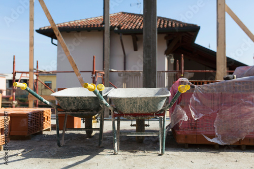Two wheelbarrows on terrace under construction photo