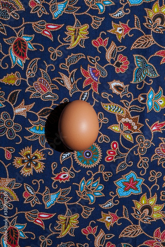 An egg on a colorful pattern.