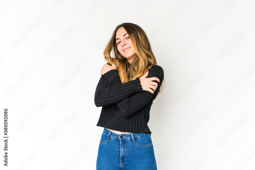 Young caucasian woman isolated on white background hugs, smiling carefree and happy. Young caucasian woman isolated on white background hugs, smiling carefree and happy.
