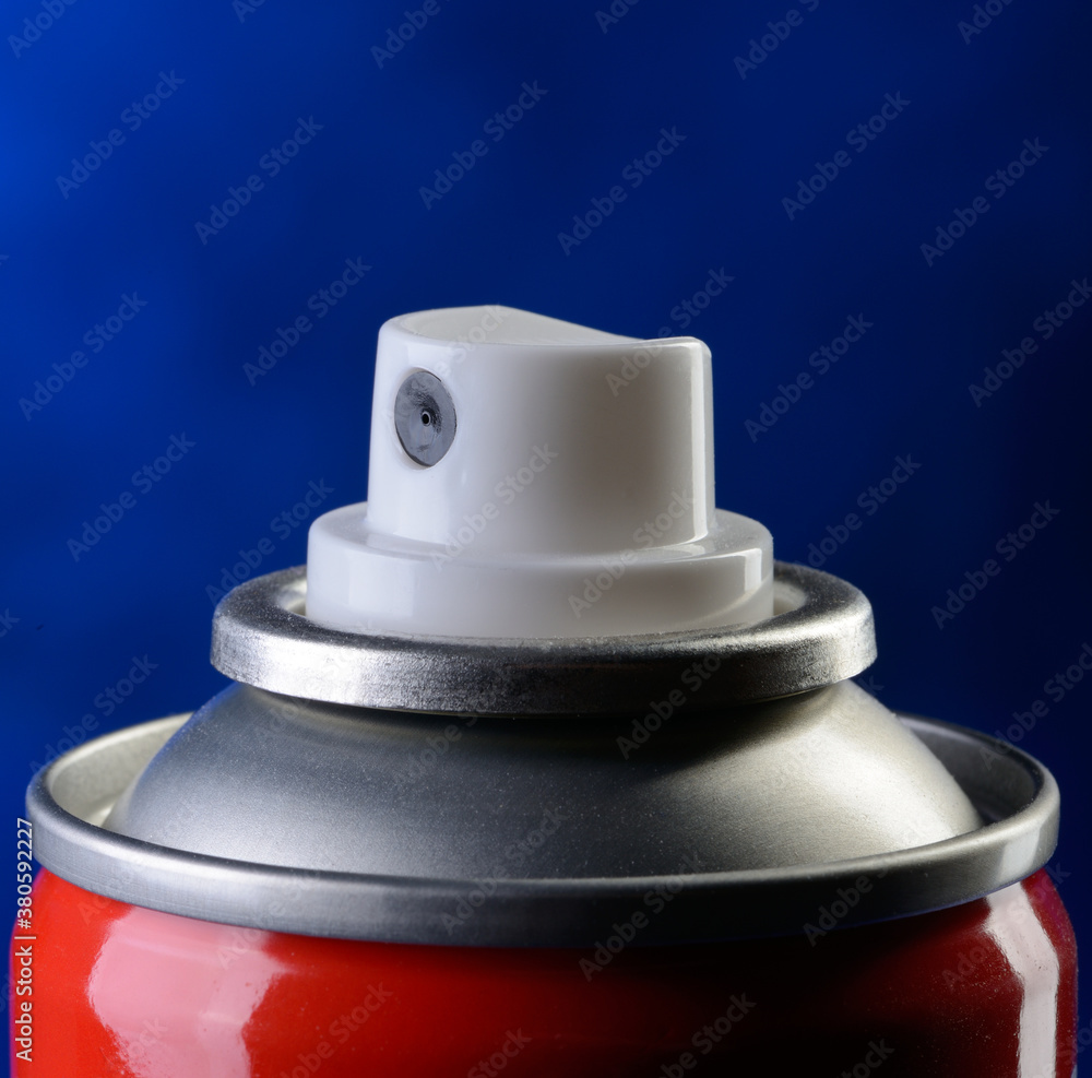 Fototapeta premium Detail of spray can on blue background