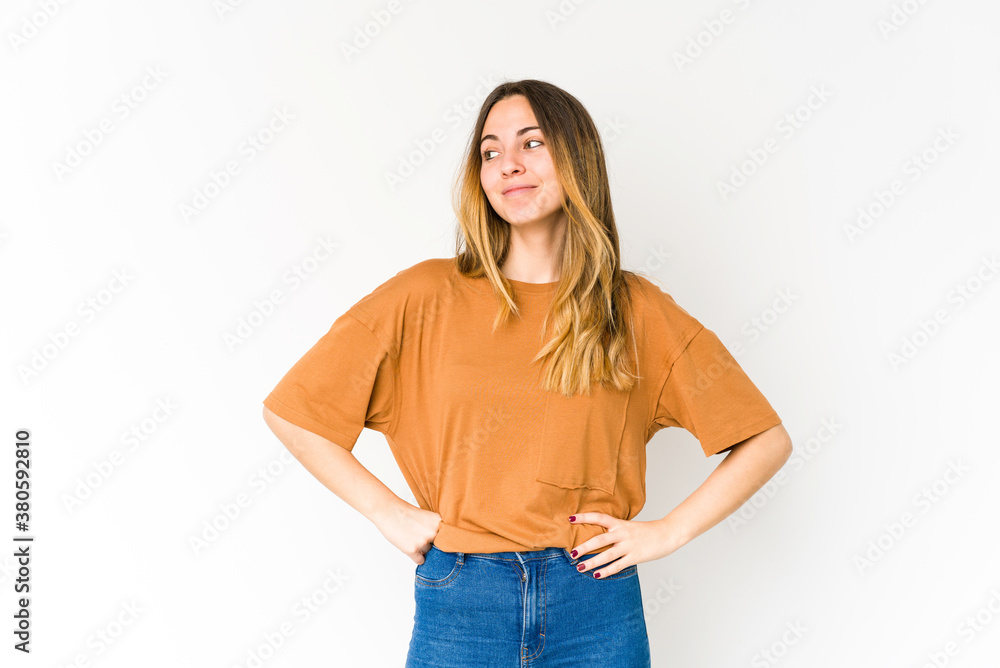 Young caucasian woman isolated on white background dreaming of achieving goals and purposes