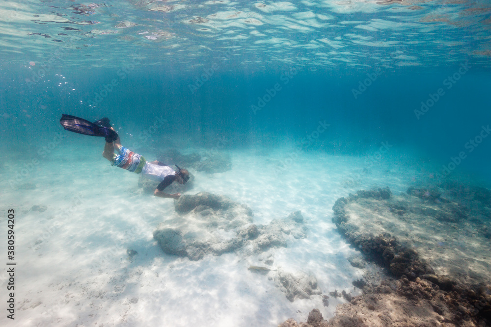 Young blond man snorkeling in tropical waters Young blond man snorkeling in tropical waters