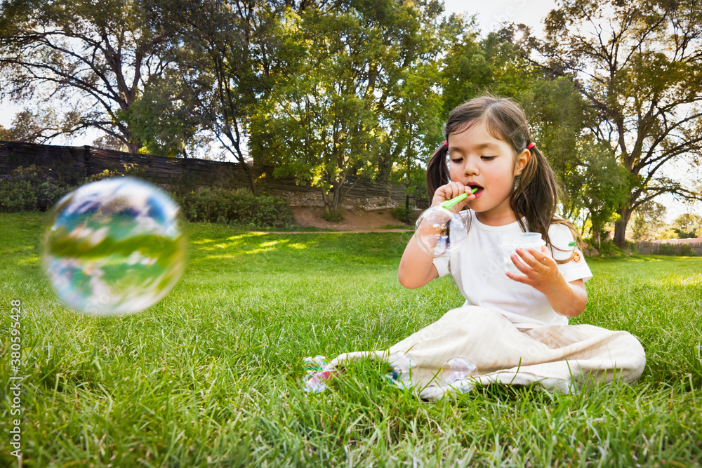 Little girl, blowing dreamy soap bubbles Little girl, blowing dreamy soap bubbles