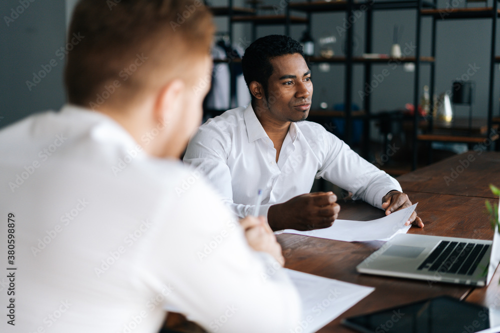 Fototapeta premium Portrait of handsome African American business man listening business idea, increasing sales, analyzing statistics, work results report, negotiating on new business project.