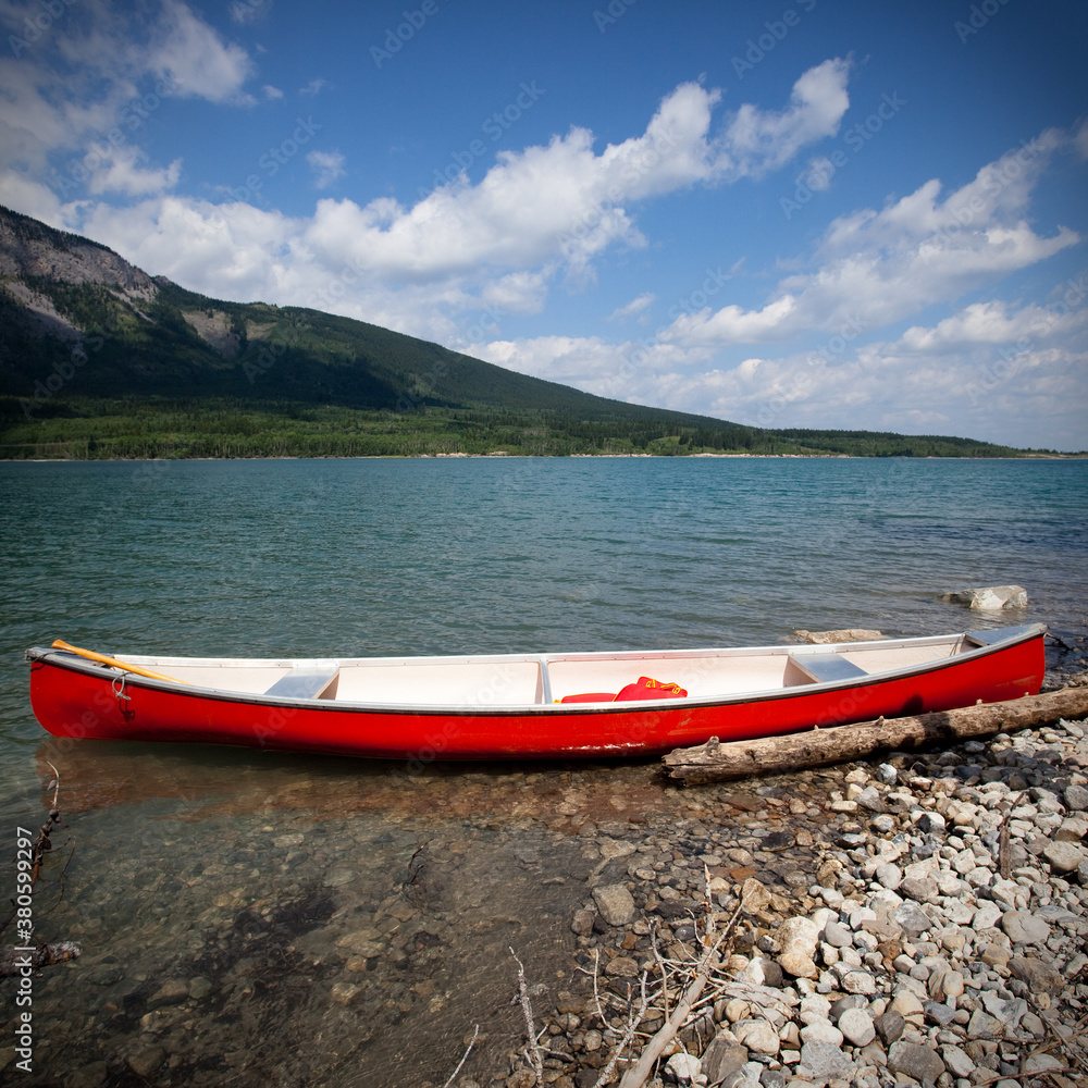 Red boat on a mountain lake in Alberta Red boat on a mountain lake in Alberta