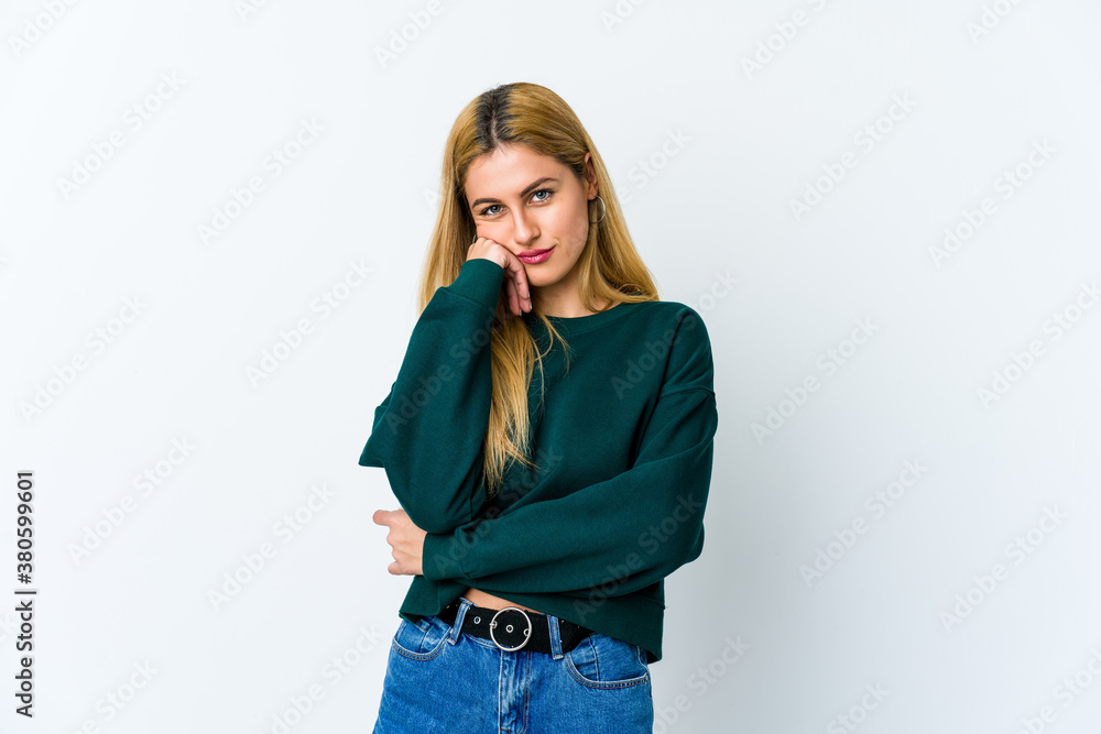 Young blonde woman isolated on white background who feels sad and pensive, looking at copy space. Young blonde woman isolated on white background who feels sad and pensive, looking at copy space.
