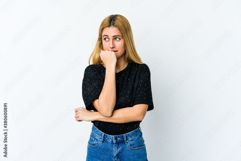Young blonde woman isolated on white background biting fingernails, nervous and very anxious. Young blonde woman isolated on white background biting fingernails, nervous and very anxious.