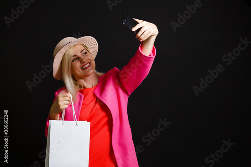 Elegant woman holding black shopping bags, black friday concept