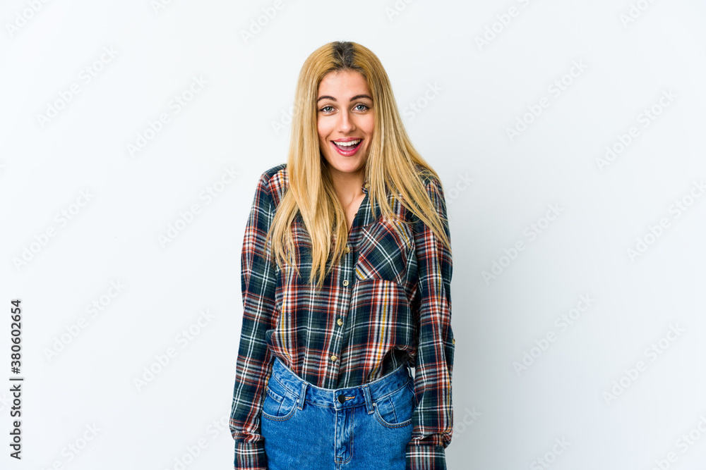 Young blonde woman isolated on white background laughs and closes eyes, feels relaxed and happy. Young blonde woman isolated on white background laughs and closes eyes, feels relaxed and happy.