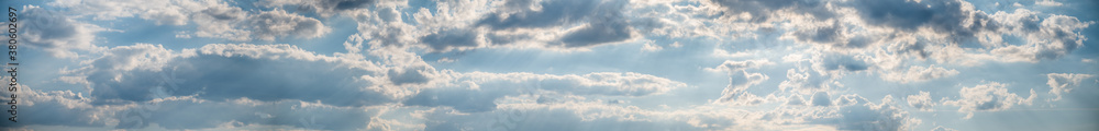 Panorama of blue sky with fluffy white clouds. Abstract background.