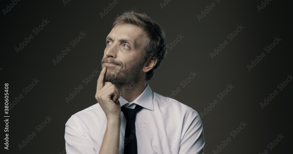 Pensive man thinking with hand on chin Pensive man thinking with hand on chin