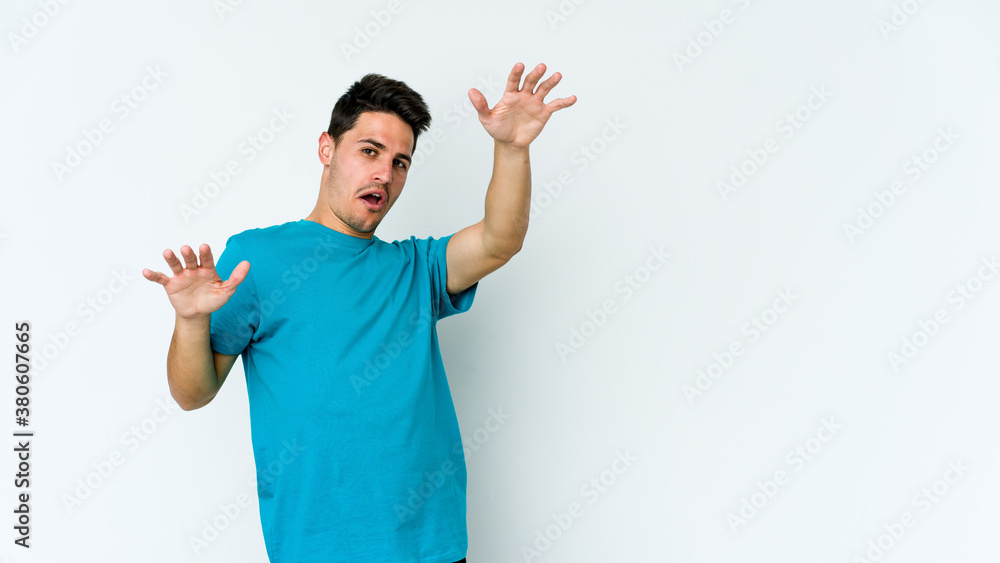 Young caucasian man isolated on white background being shocked due to an imminent danger Young caucasian man isolated on white background being shocked due to an imminent danger