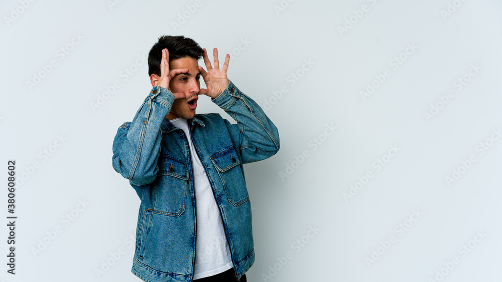 Young caucasian man isolated on white background keeping eyes opened to find a success opportunity. Young caucasian man isolated on white background keeping eyes opened to find a success opportunity.