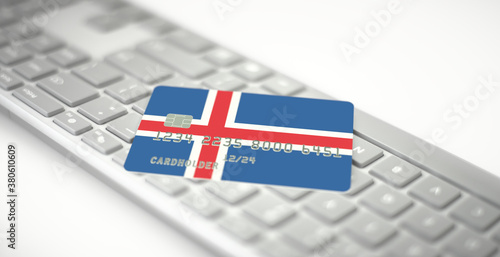 Credit card depicting flag of Iceland on computer keyboard. Fictional numbers
