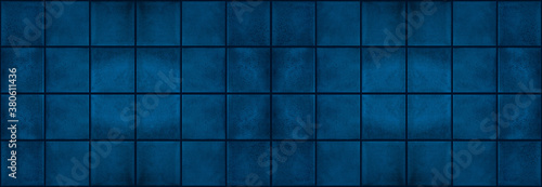 Seamless dark grunge blue square mosaic concrete cement stone wall tiles pattern texture wide background banner