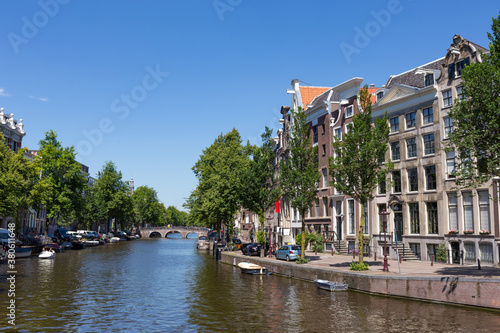 Historical canal houses on the Keizersgracht in the center of the Amsterdam with a blue sky in the Netherlands. © misign