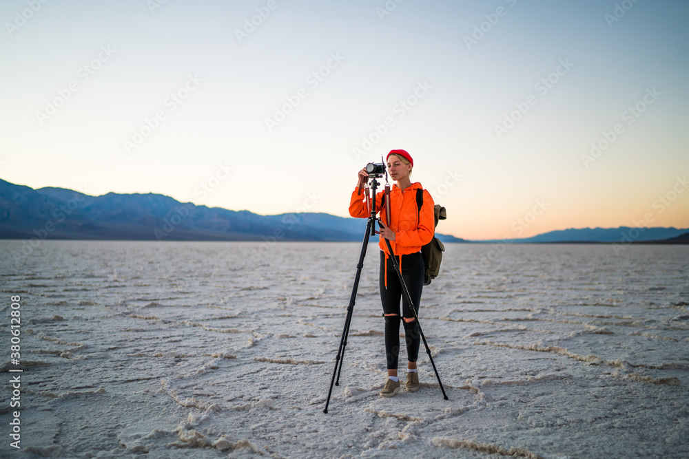 Female photographer shooting terrain during sunset