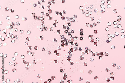 Golden sparkles on pink pastel background. Festive backdrop for your projects