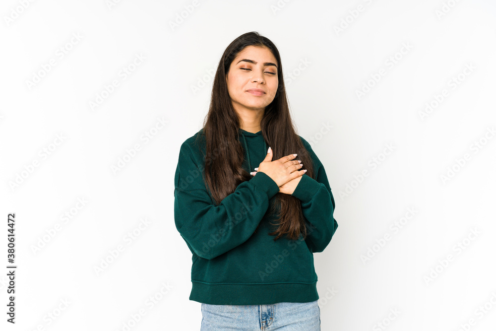 Young indian woman isolated on purple background has friendly expression, pressing palm to chest. Love concept. Young indian woman isolated on purple background has friendly expression, pressing palm to chest. Love concept.