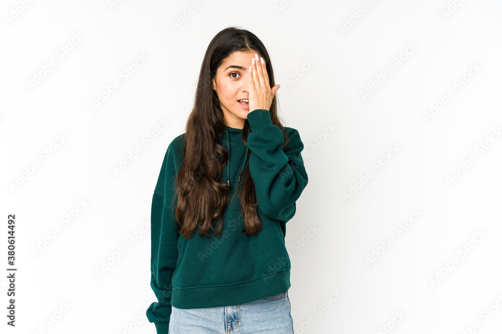 Young indian woman isolated on purple background having fun covering half of face with palm. Young indian woman isolated on purple background having fun covering half of face with palm.