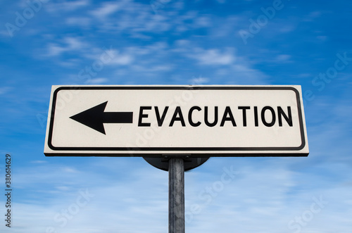 Evacuation road sign, arrow on blue sky background. One way blank road sign with copy space. Arrow on a pole pointing in one direction.