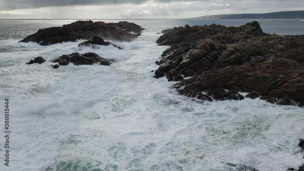 flying through a canal of rocks during a storm, waves crashing on the rocks. Along the coastline of Western Australia 4k drone shot. flying through a canal of rocks during a storm, waves crashing on the rocks. Along the coastline of Western Australia 4k drone shot.