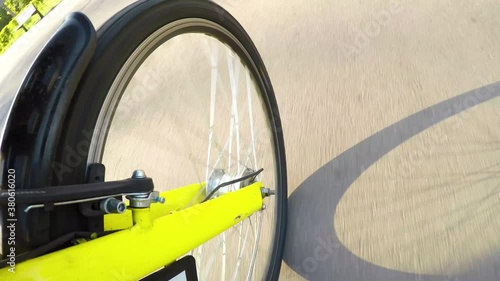 Courier service on bicycle. Delivery service on the bike. Yellow bike, front wheel view.