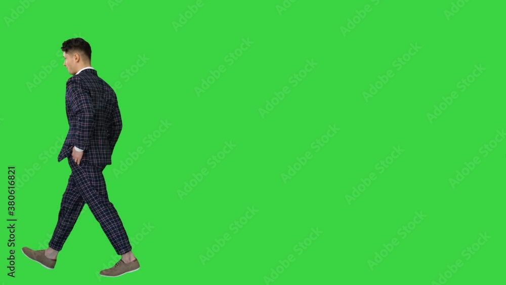Young cool elegant man walking by on a Green Screen, Chroma Key. Young cool elegant man walking by on a Green Screen, Chroma Key.