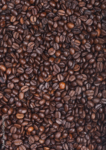 Fresh raw organic coffee beans top view background.
