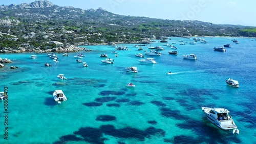 Aerial Drone View over Cala Serena at Caprera Island, Sardinia. Bay Full of Boats and Luxury Yachts. Cristal Clear Turquoise Water. Rocky Coast. photo