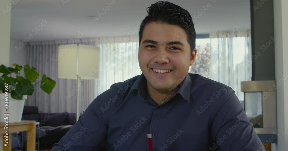 Young man happily smiles in the camera. Young man happily smiles in the camera.