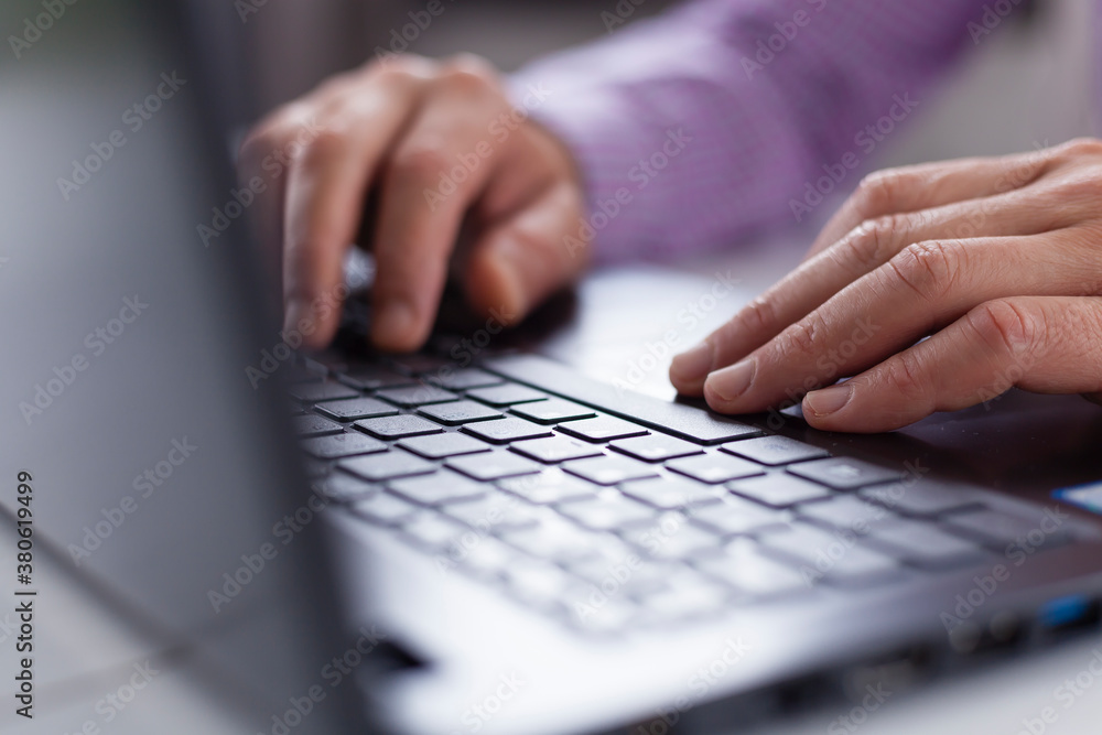 Male executive hands typing and scrolling on a laptop computer device with blur background. Working online from home.
Male executive hands typing and scrolling on a laptop computer device with blur background. Working online from home.