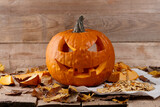 Carved Halloween pumpkin on wooden planks