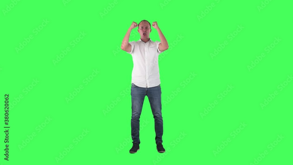 Ecstatic young fan celebrating goal screaming while watching match. Full body on green screen chroma key background. Ecstatic young fan celebrating goal screaming while watching match. Full body on green screen chroma key background.