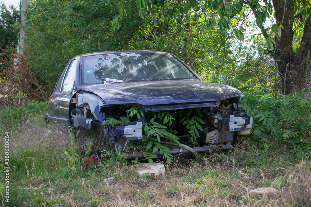 Broken abandoned car. Old vehicle running and aging. Antique damaged automobile. Forgotten wrecked junk car. 