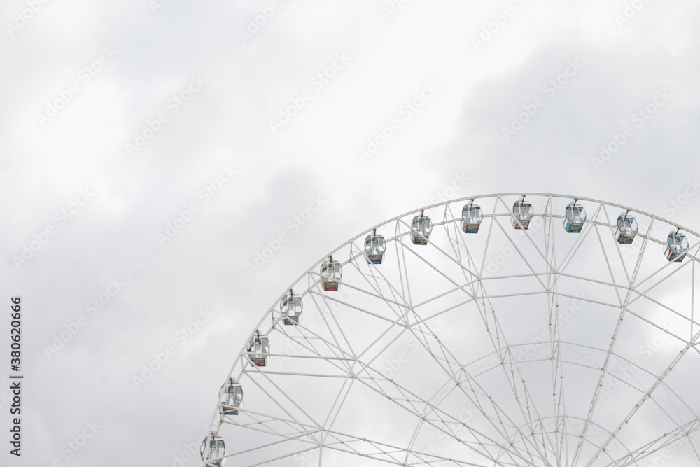 ferris wheel on a cloudy day, grey color background