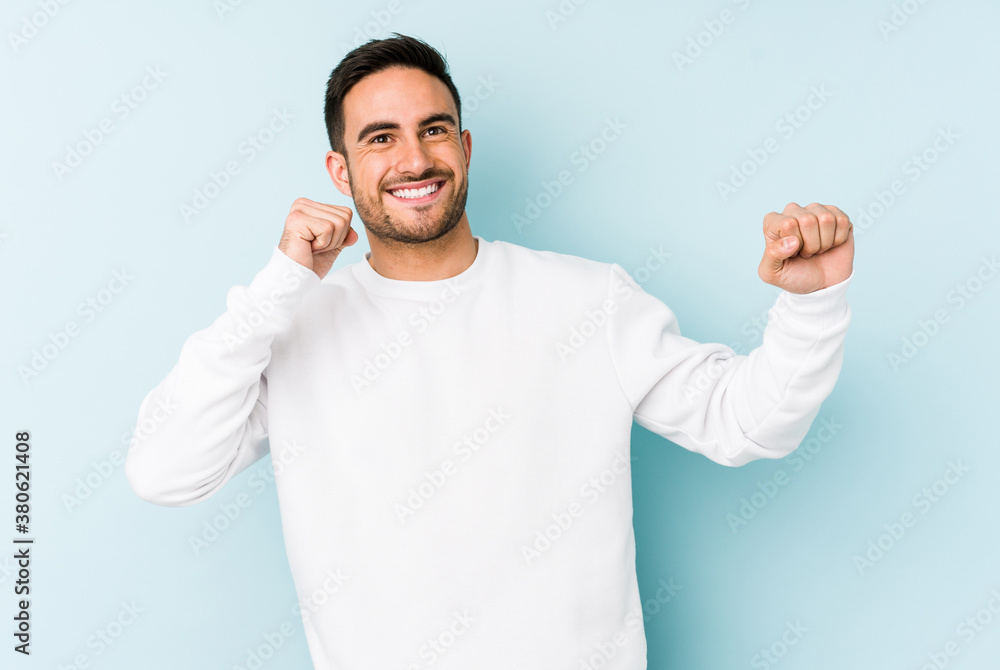 Young caucasian man isolated on blue background dancing and having fun. Young caucasian man isolated on blue background dancing and having fun.